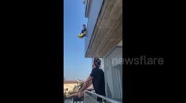 Quarantined volleyball pros play from balconies in locked down Italy
