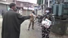 Security forces in Kashmir distribute hand sanitiser and face masks to residents