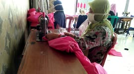 Indonesian residents sew together protective clothing for health workers combating COVID-19 pandemic