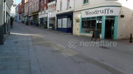 A skateboarder on an empty high street during Covid-19 lockdown.