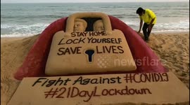 Sand artist creates 'Stay home' sculpture on beach in India
