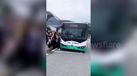 Large crowds wait to board bus after over 100 routes reopen in Wuhan