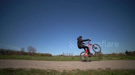 Mountainbike Athlete goes back and forth with Wheelies and tricks!