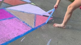 Peeling tape off of sidewalk chalk art