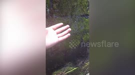 Residents catches volcanic ash in hand as Mount Merapi erupts in Indonesia
