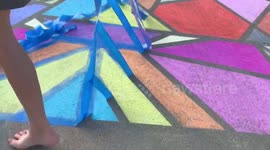 Sidewalk art made from chalk satisfyingly revealed after removing tape