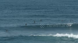 surfers riding waves in the ocean off fuertventura