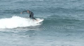 surfers riding waves in the ocean off fuertventura