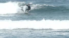 surfers riding waves in the ocean off fuertventura