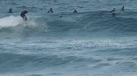 surfers riding waves in the ocean off fuertventura