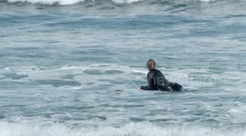 surfers riding waves in the ocean off fuertventura