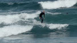 surfers riding waves in the ocean off fuertventura