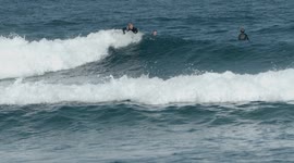 surfers riding waves in the ocean off fuertventura