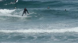 surfers riding waves in the ocean off fuertventura