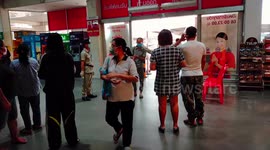 Supermarket shoppers in Thailand having their temperature checked on entry to a store.