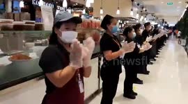Supermarket staff in Bangkok clap to show support for COVID-19 medical workers