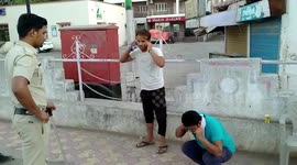 Cops shame lockdown violators by making them do sit-ups, while also help feed needy in western India