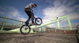 BMX Bike Action: High Bunny Hop Jump on a bridge with traffic