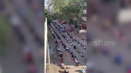 Thousands of stranded migrant workers in India queue outside bus station waiting to go back to their hometowns