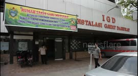 Medical workers examine patients at COVID-19 screening center in Indonesia