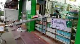 Laotian pharmacy uses DIY slide and toy truck to hand over medicine during coronavirus pandemic