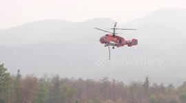 Helicopters dump water on forest fires ravaging northern Thailand