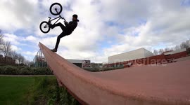 Man does trick on BMX Bike in cool Skatepark