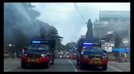 Government officers hose disinfectant onto streets in Indonesia
