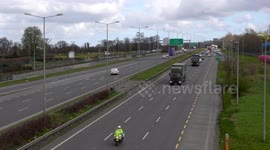 Irish police and Defence Forces escort convoy loaded with protective gear through Dublin