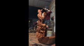 The man sculpting rooster from the large wood