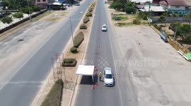 Thai police check temperature of drivers fleeing Bangkok as COVID-19 exodus continues