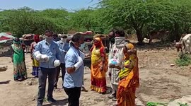 Employees of electric company distribute food packets to several poor families stranded amid lockdown in western India