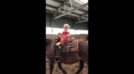 One year old riding a horse