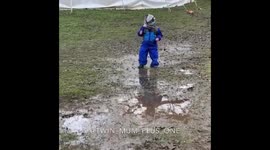 Toddler playing in the mud trips and falls