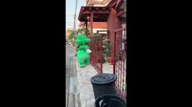 Thai delivery man in dragon costume delivers food during COVID-19 lockdown