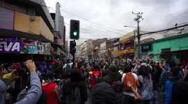 People singing and protesting as they confront military and special forces in the city center