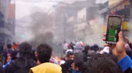 People singing and protesting as they confront military and special forces in the city center