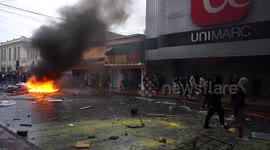 Destroyed amid protests, a looted super market