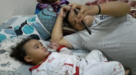 staying home due to the corona virus, a 2-year-old girl watching a video