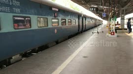 Dramatic moment man rushes to help woman who fell off moving train in India