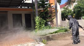 Police in Indonesia spray disinfectant on homes amid coronavirus pandemic