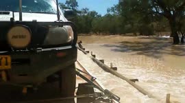 Vehicle drives through flooded roads after river overflows in western Queensland, Australia
