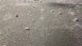 Watch South Dakota driver smash thick layer of ice off his car as extreme freezing rain continues.
