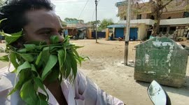 Indian man wears 'mask' of neem leaves believing it protects him from coronavirus