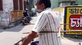India man surrounds himself with sticks as preventive measure against coronavirus