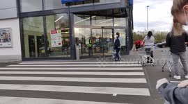 Due to Coronavirus people have to queue in front of the supermarket as they only allow a small number of people inside the store.