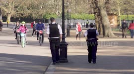 Police try to enforce social distancing in Hyde Park in London during coronavirus lockdown