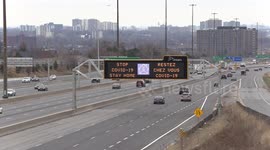 Signs on highway 401 in Toronto Canada warn people to stay home as COVID 19 pandemic worsens rapidly