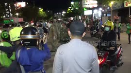 Police in Indonesia city disperse crowds gathering in cafes during COVID-19 pandemic