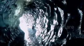 Icelandic tour guide navigates through spectacular glacier tunnel